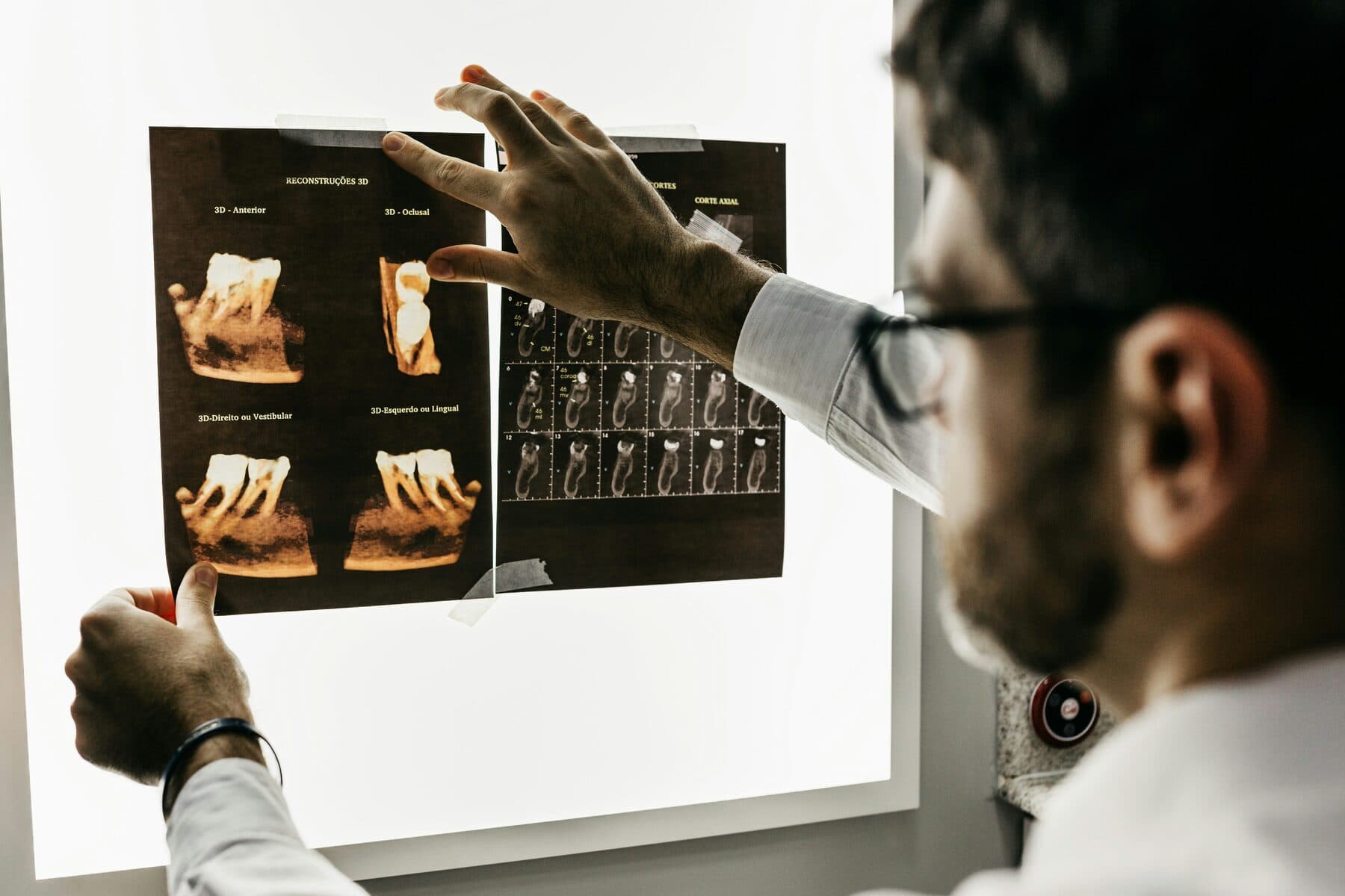 Dentist reviewing 3D dental X-ray reconstructions